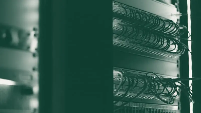 A rack of network equipment in a dark room