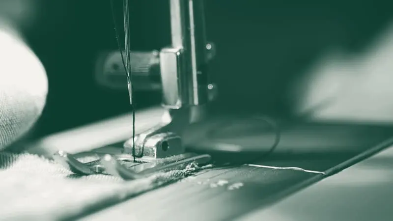 A sewing machine and thread, close up